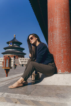brunette girl sitting on the steps by temple of heven in China