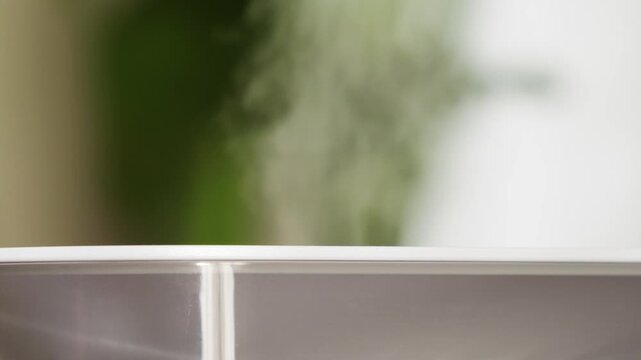 A modern humidifier that produces cool water vapor to moisturize the air in a home and prevent respiratory infections. High quality 4k footage