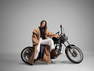 Young woma posing on vintage motorcycle