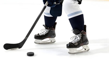 Obraz premium Ice Hockey Player with Stick and Puck on Ice Rink