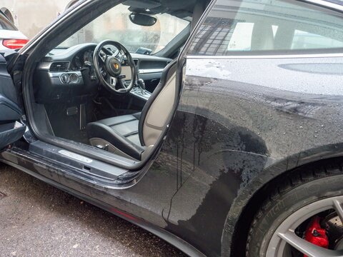 Porsche Carrera 4S interior and wet exterior detail on a rainy day