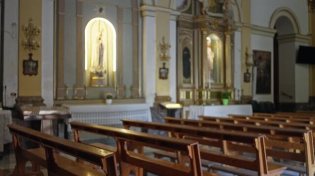 Blurred catholic interior with soft shallow bokeh and wooden pews church; background backplate copyspace calm.