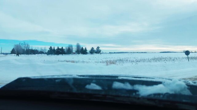 Dash camera footage of a drive down a snowy country road