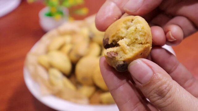 lady hands  segregating chocolate chip cookies in baking tray