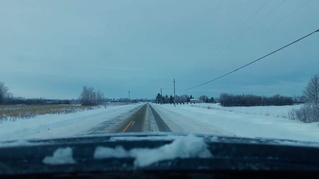 Dash camera footage of a drive down a snowy country road