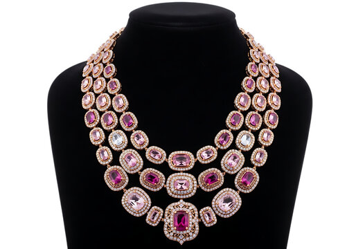 Luxurious multi-strand necklace featuring large pink gemstones on a black velvet mannequin