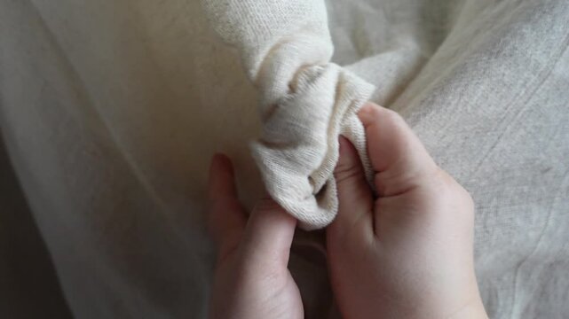 ASMR close-up of hands touching organic beige linen fabric. Features crisp rustling sound of natural material. Ideal for sensory, eco-friendly, and textile design projects 
