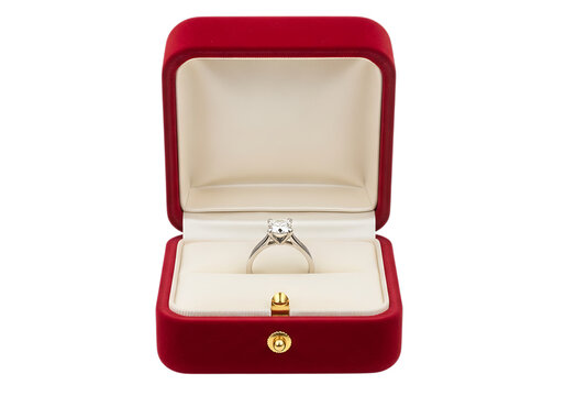 Luxurious red ring box containing a diamond engagement ring on a white background.