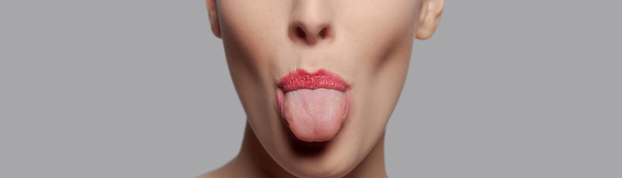Woman Sticking Out Tongue With Red Lipstick Closeup
