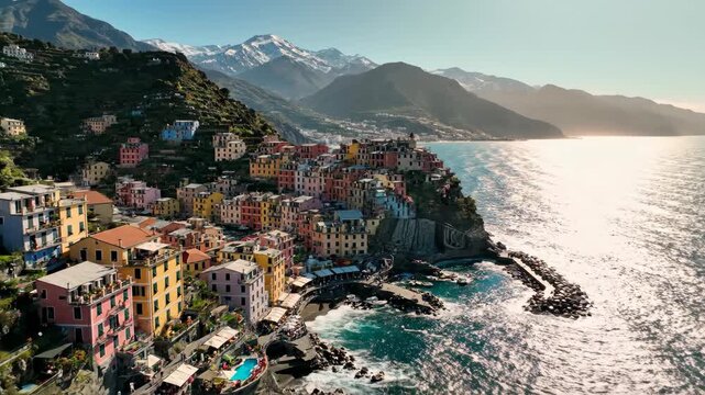 Vibrant Manarola village on steep Italian coast with mountains