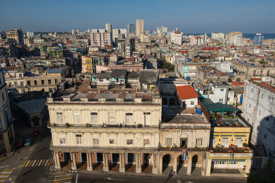 Aerial cityscape view - old crumbling building, weathered worn facades and shingled roofs with water tanks, overpopulated city, Havana, Cuba. 