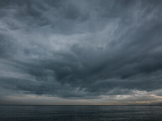 Fototapeta premium Rain clouds over calm sea