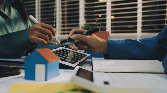 Business leaders discuss implement environmental sustainability strategies net zero carbon goals corporate responsibility using ESG reports data at meeting