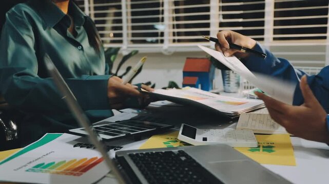 Business leaders discuss implement environmental sustainability strategies net zero carbon goals corporate responsibility using ESG reports data at meeting
