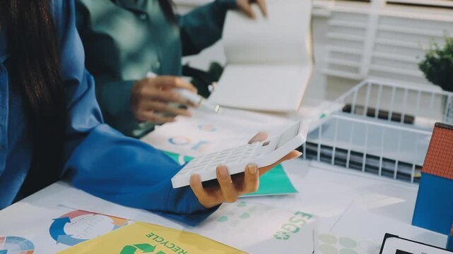 Business leaders discuss implement environmental sustainability strategies net zero carbon goals corporate responsibility using ESG reports data at meeting