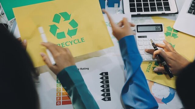 Business leaders discuss implement environmental sustainability strategies net zero carbon goals corporate responsibility using ESG reports data at meeting