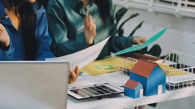 Business leaders discuss implement environmental sustainability strategies net zero carbon goals corporate responsibility using ESG reports data at meeting