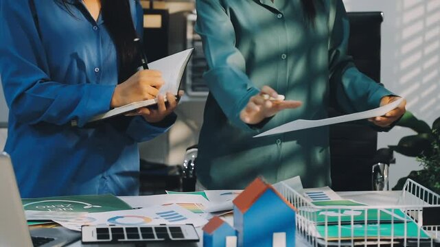 Business leaders discuss implement environmental sustainability strategies net zero carbon goals corporate responsibility using ESG reports data at meeting