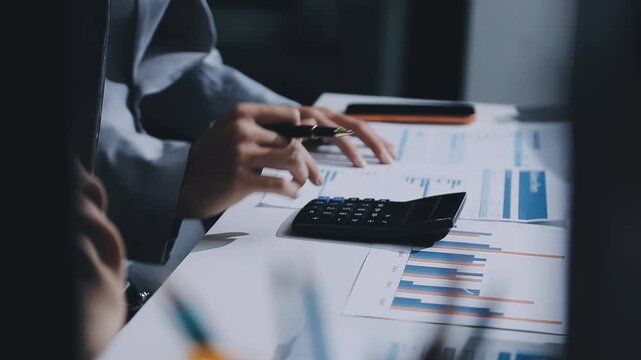 Doing finance, budgeting and tax calculation. Close up woman hand using calculator to calculate home finance, accounting with laptop computer on table, budget management, monthly expenses.