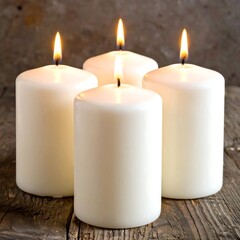 Four lit, white pillar candles burning on a weathered wood surface with neutral background