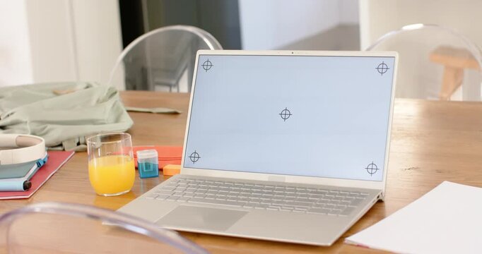 Camera is pushing in and panning right, focusing laptop and revealing crosshairs on wooden table