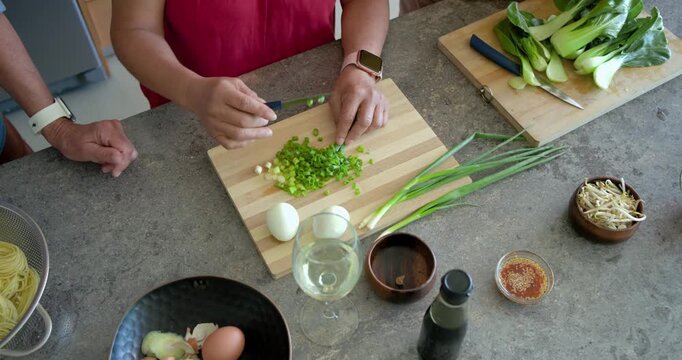 Yellow arriving at counter red chopping scallion blue peeling egg yellow trimming bok choy for meal