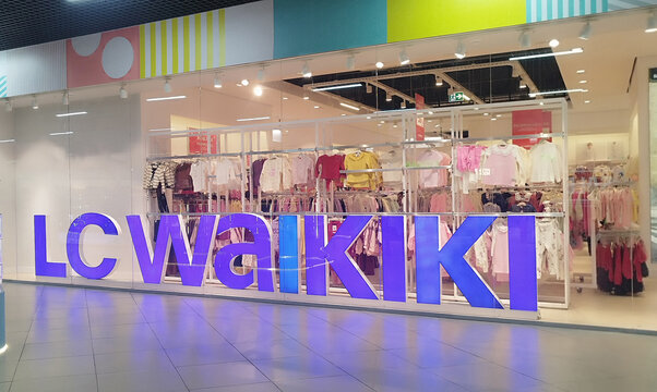 Karaganda, Kazakhstan - February 6, 2026: In the brightly lit window of a children's clothing store in a shopping mall, a huge purple "LC Waikiki" logo stands out, illuminated from above.