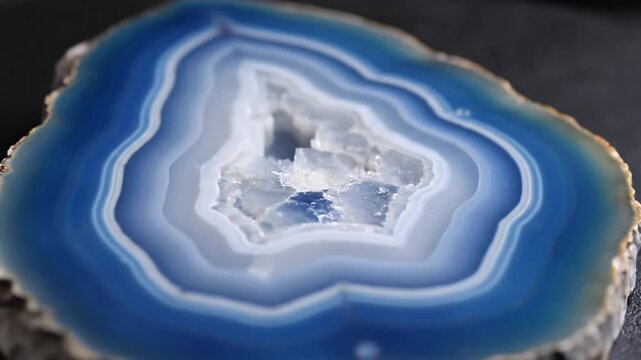 A close-up view of a sliced stone showing a captivating pattern of blue and white layers