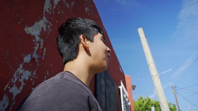 Latino teenager eating mexican street food tacos