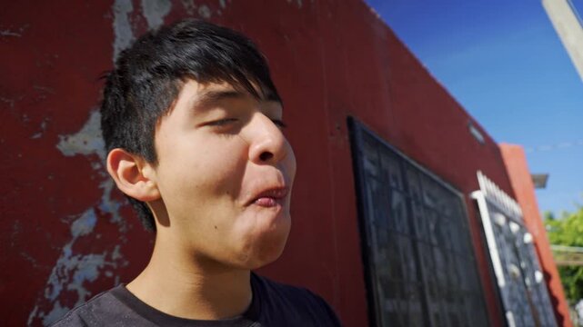 Hispanic teenager eating a delicious mexican street food taco