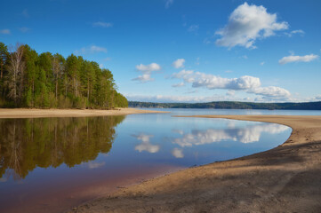 Obraz premium View of the Kama River from the sandy shore on a sunny summer day.