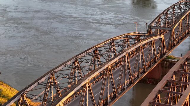 Panoramic aerial perspective capturing Ponte di Ferro sul Po a Cremona a vital transportation artery crossing the expansive Po River connecting Cremona with Castelvetro Piacentino, slow motion shot