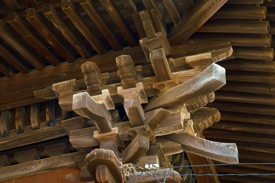 Sakata, Yamagata, japan - Oct 5 2024, A close-up view of the carved wooden interior elements dougong located under the roof vaults of the Jinchi-ji Temple, Sakata, Japan