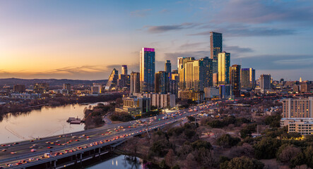 Aerial drone view of sunset over the dramatic skyline of Austin Texas in early 2026 showing new residential towers in downtown © steheap