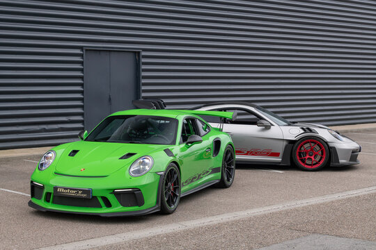 Metz, France - October 16th 2025 : View on a green Porsche 991 GT3 RS finished in Lizard green and a grey Porsche 992 GT3 RS Weissach Package finished in Argent GT with the Pyro red rims on a street.