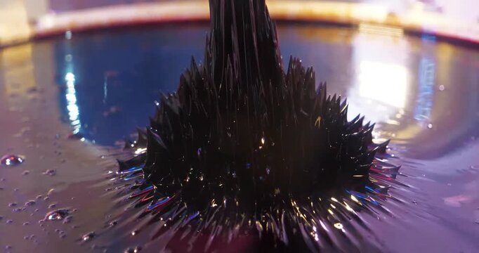 Real ferromagnetic fluid in action. Ferromagnetic fluid. Viscous ferrofluid spike-like shape. Ferromagnetic fluid creates amazing drawings spikes in magnetic field, appearing and disappearing
