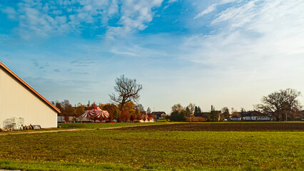 Autumn or indian summer view with a red and white circus tent at Moos, Deggendorf, Bavaria, Germany © Martin Erdniss