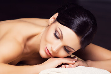 Young, healthy and beautiful woman gets massage therapy in the spa salon. Healthy lifestyle and body care concept.