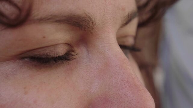 Close-up of young woman eyes opening slowly with a hopeful expression. Symbolic moment representing optimism, awareness and positive outlook toward the future.