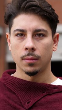 Vertical, Medium shot of a man winking mischievously with a playful grin. His expression suggests a lighthearted and fun attitude, adding a touch of humor.