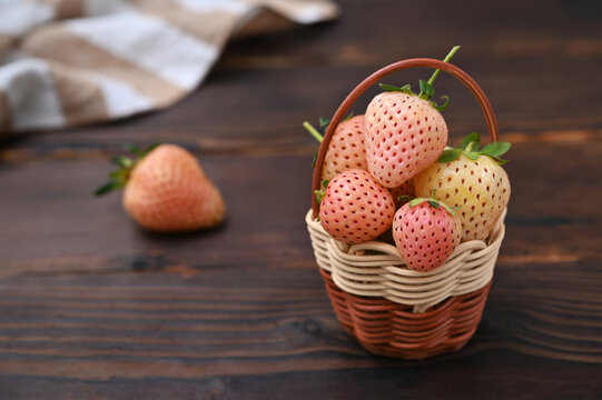 a basket of delicious pineberries on the table