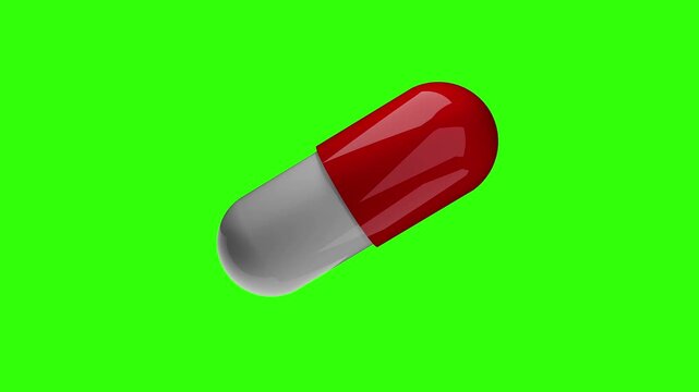 A 3d rendered medical capsule pill with a glossy red and white finish rotating in a continuous loop. The pharmaceutical object is isolated on a bright green chroma key background