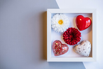 Heart-Shaped Objects in White Box with Flowers in Soft Natural Lighting for Valentines Day Gift