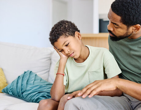 Portrait of a teenage boy son talking to his father at home. Sharing secrets and problems, support and parenthood concept