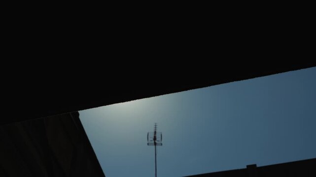 Opening shutters early in the morning a person lets in the first rays of the sun on a sunny day. High quality 4k footage