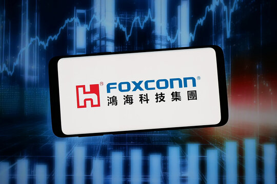 Stuttgart, Germany - 02-09-2026: In this photo illustration, the logo of Hon Hai Precision Industry Co. Ltd. (Foxconn) is displayed on a smartphone in front of abstract background on computer screen.