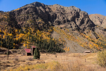Rugged Mountain Peaks and Autumn Aspens in Valley Landscape