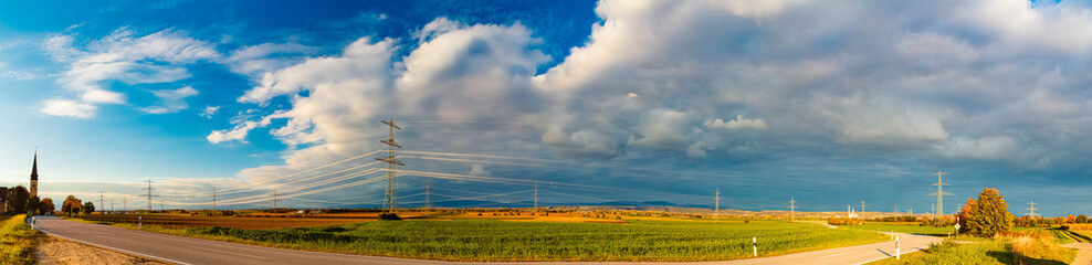Obraz premium Autumn or indian summer view with a dramatic sky and overland high voltage lines soon to be replaced by Ostbayernachse at Wallerdorf, Kuenzing, Deggendorf, Bavaria, Germany