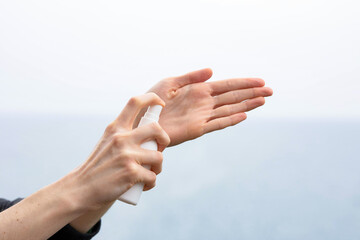 Hands spraying sanitizer for personal hygiene
