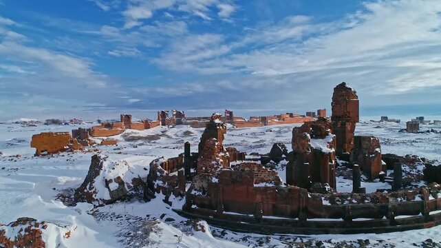 Aerial view of the Abughamrents Church ruins at Ani in Kars, Turkey. Snow covered medieval Armenian architecture stands within the vast winter landscape of the ancient city.